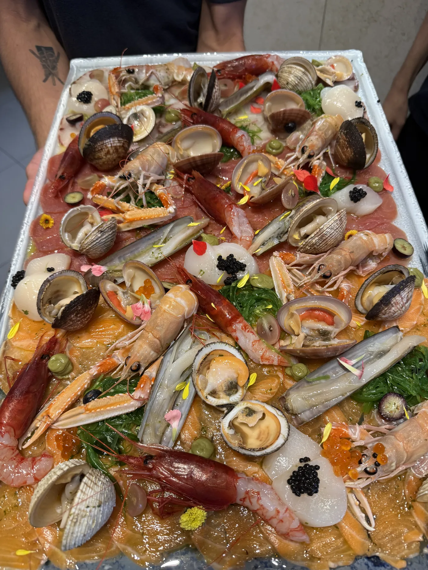A large platter of shellfish and crudo for a group